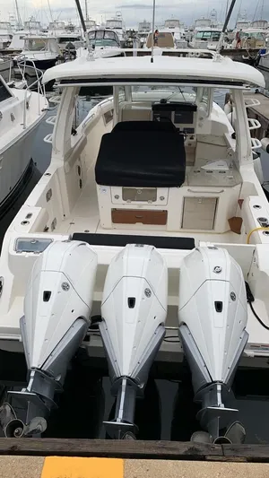  Yacht Photos Pics 2021 Boston Whaler 350 Realm with triple outboard engines docked at marina.