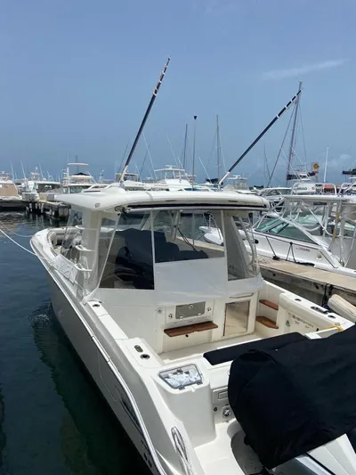  Yacht Photos Pics 2021 Boston Whaler 350 Realm docked at marina, showcasing sleek design and spacious deck.