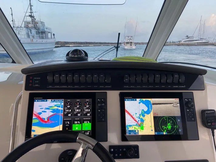  Yacht Photos Pics Cockpit view of 2021 Boston Whaler 350 Realm with navigation screens and controls.