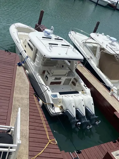  Yacht Photos Pics 2021 Boston Whaler 350 Realm docked, featuring triple outboard engines.