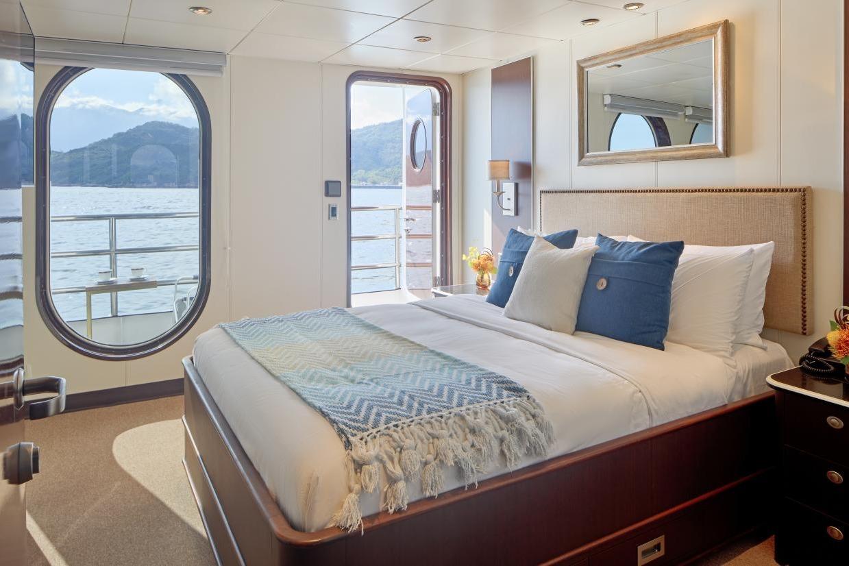 Luxurious bedroom on 1982 Shadow Marine Custom Expedition Yacht with ocean view.