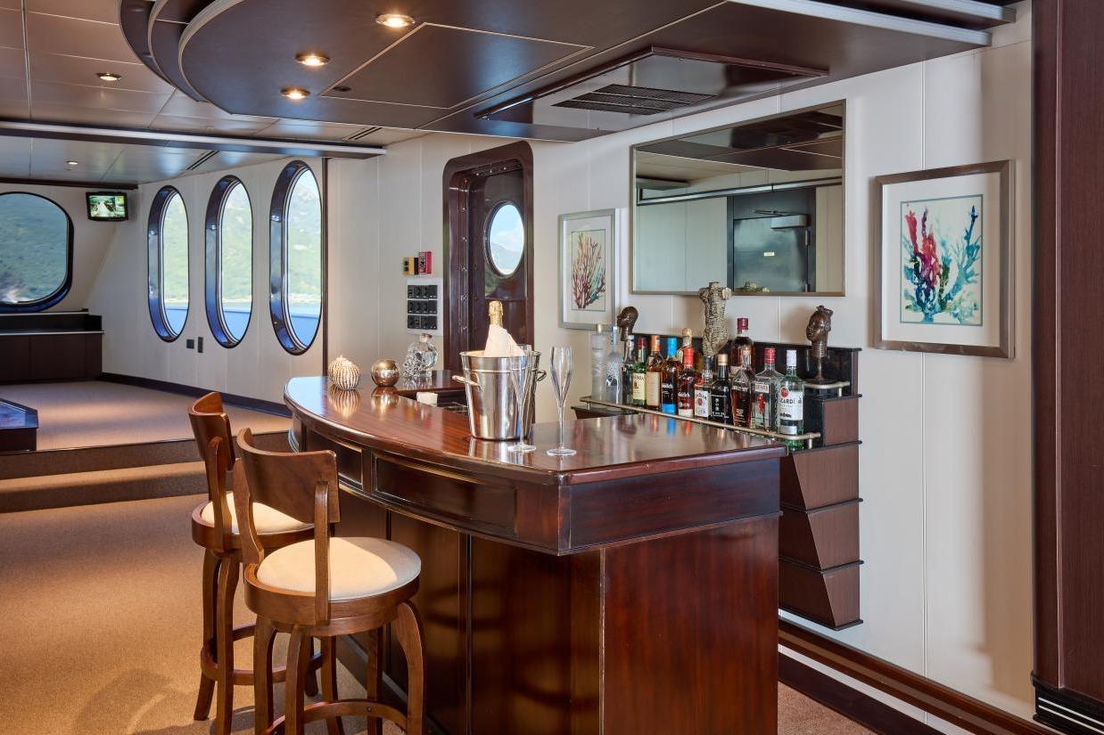 Luxurious bar area on 1982 Shadow Marine Custom Expedition Yacht with elegant wood finishes.