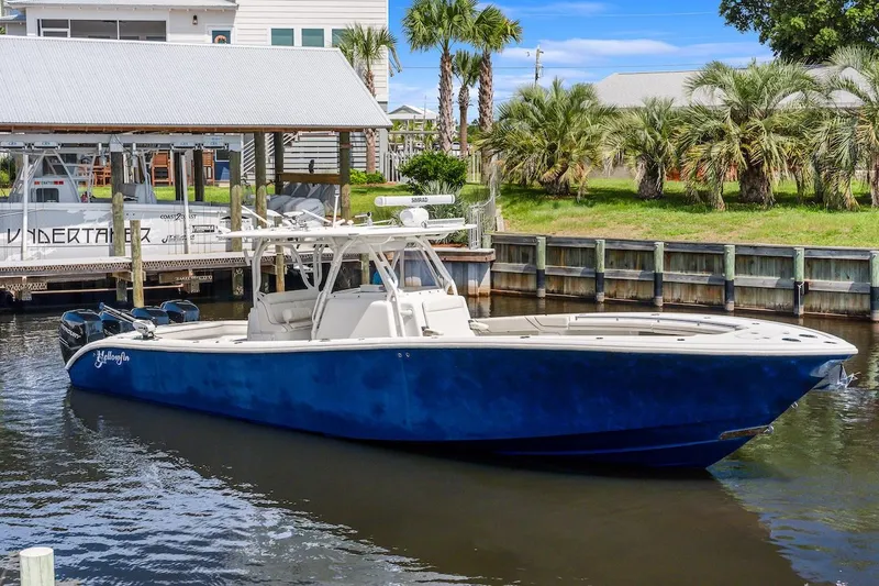  Yacht Photos Pics 2015 Yellowfin 39 boat docked, featuring a sleek blue hull and spacious deck.