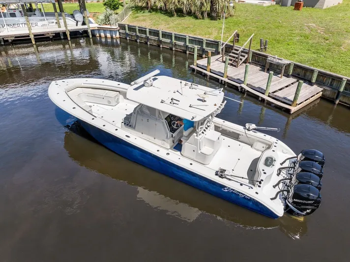  Yacht Photos Pics 2015 Yellowfin 39 boat with quad Mercury engines docked in a canal.