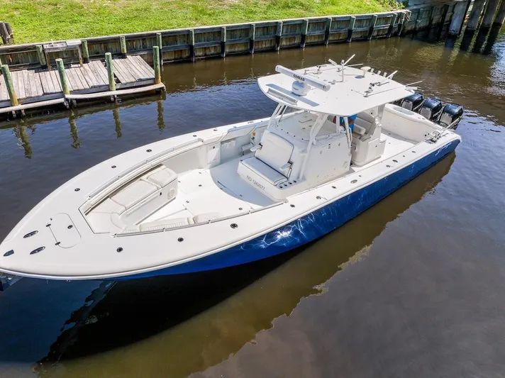  Yacht Photos Pics 2015 Yellowfin 39 boat docked on calm water, featuring sleek design and spacious deck.