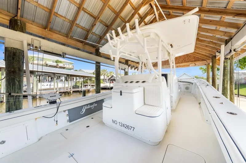  Yacht Photos Pics 2015 Yellowfin 39 boat docked under a wooden shelter.