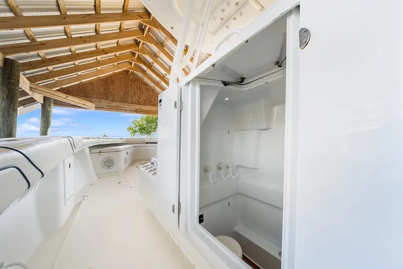  Yacht Photos Pics 2015 Yellowfin 39 boat interior with open storage compartment under a wooden canopy.