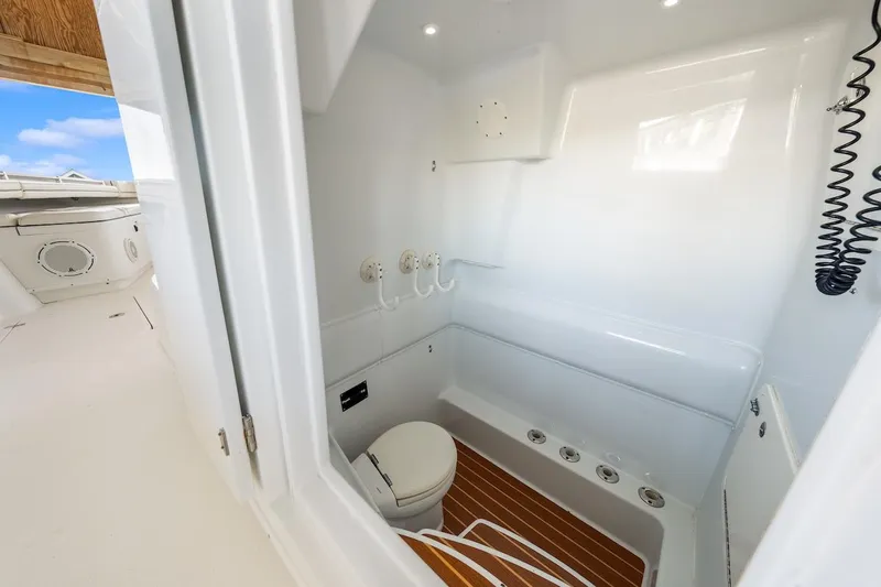  Yacht Photos Pics 2015 Yellowfin 39 boat interior with white cabin and wooden floor.