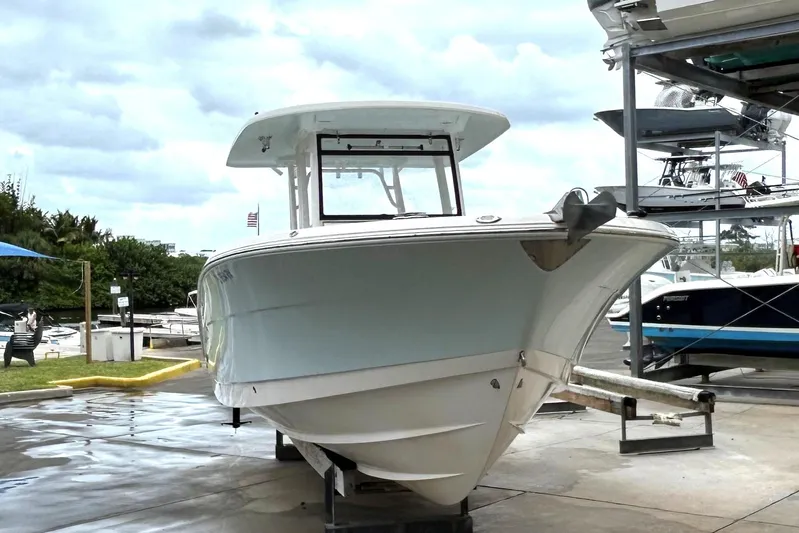 302-176 Brokerage Anthony Yacht Photos Pics 2018 Robalo R302 Center Console boat on a trailer at a marina.