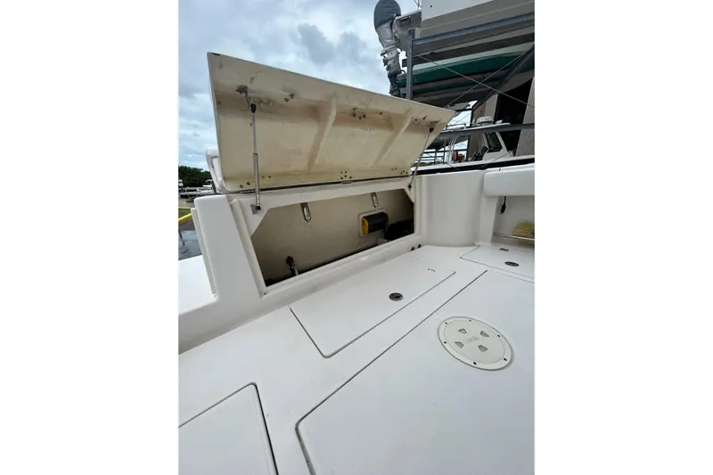302-176 Brokerage Anthony Yacht Photos Pics 2018 Robalo R302 Center Console boat with open storage compartment on deck.