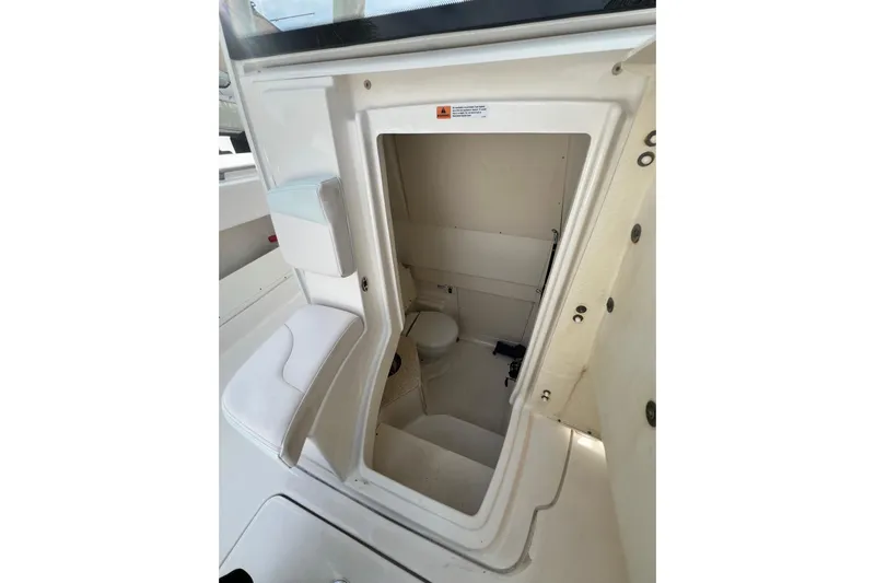 302-176 Brokerage Anthony Yacht Photos Pics 2018 Robalo R302 Center Console boat interior with compact marine toilet.