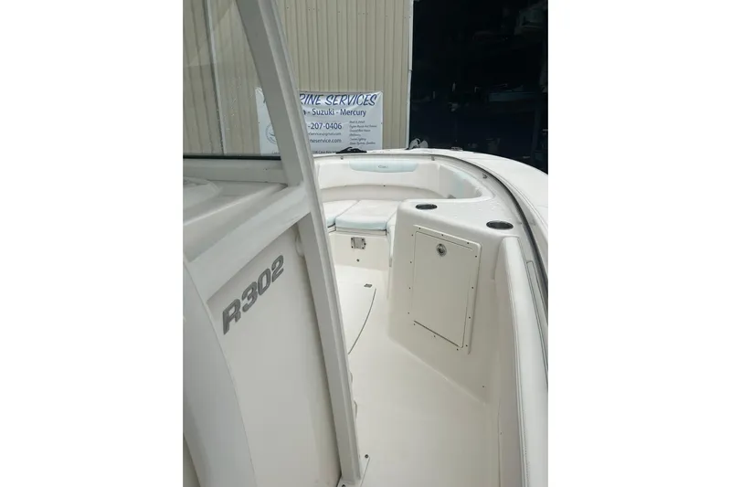 302-176 Brokerage Anthony Yacht Photos Pics 2018 Robalo R302 Center Console boat interior, showcasing seating and storage compartments.