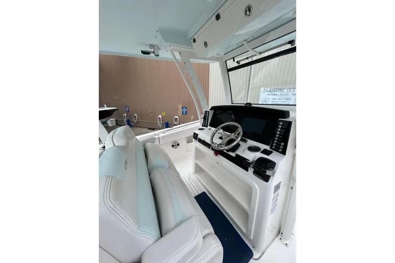 302-176 Brokerage Anthony Yacht Photos Pics 2018 Robalo R302 Center Console boat interior with steering wheel and control panel.