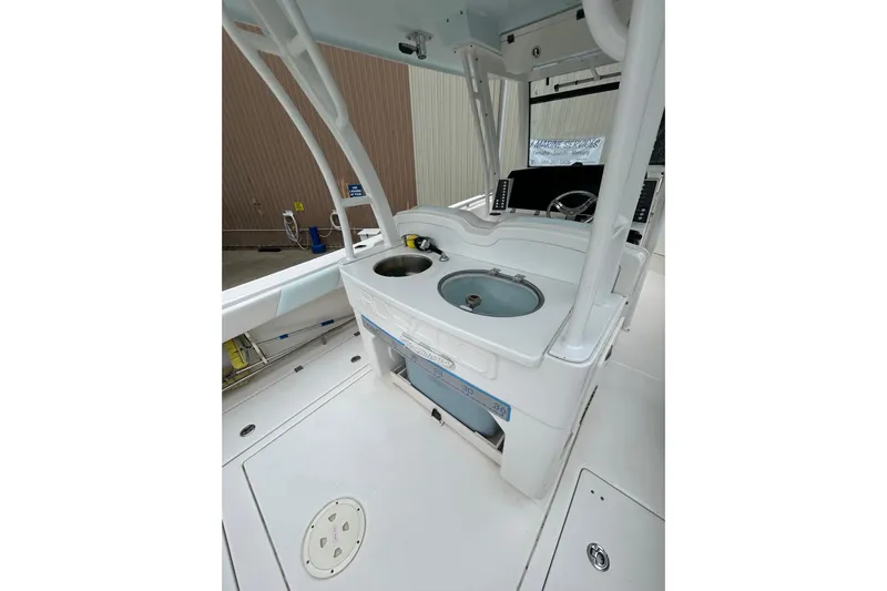 302-176 Brokerage Anthony Yacht Photos Pics 2018 Robalo R302 Center Console boat interior with helm and storage compartments.