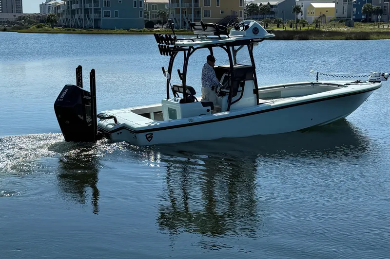 Island Time Yacht Photos Pics 2020 BARKER 26 boat cruising on calm water near waterfront homes.