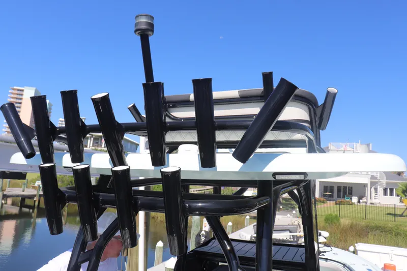 Island Time Yacht Photos Pics Fishing rod holders on a 2020 BARKER 26 boat, docked near waterfront homes.