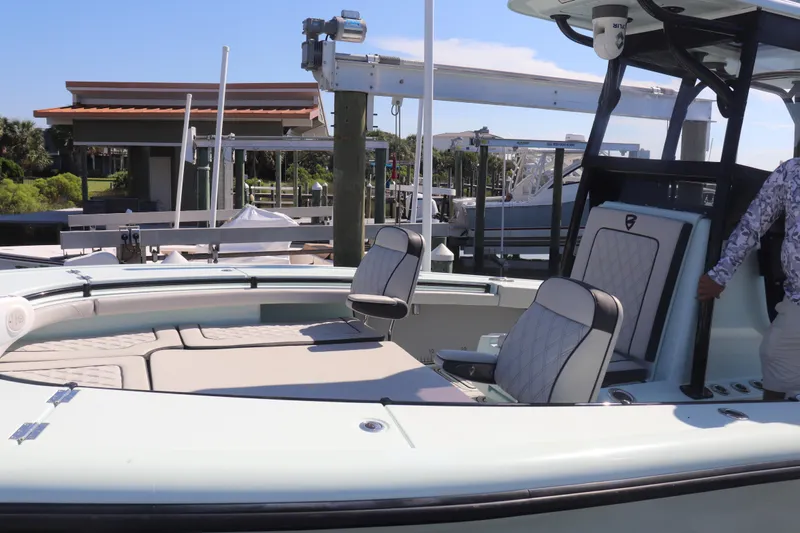 Island Time Yacht Photos Pics 2020 BARKER 26 boat with cushioned seating at a marina dock.