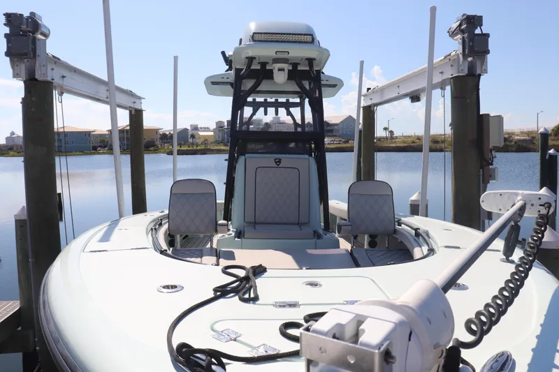 Island Time Yacht Photos Pics 2020 BARKER 26 boat docked on a lift, with a scenic waterfront view.