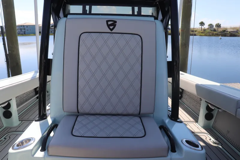 Island Time Yacht Photos Pics Luxury seating on a 2020 BARKER 26 boat, featuring diamond-stitched upholstery by the water.