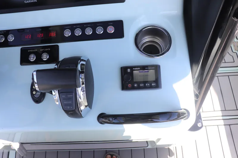 Island Time Yacht Photos Pics Boat control panel with throttle, Fusion stereo, and cup holder on a 2020 Barker 26 model.