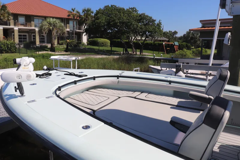 Island Time Yacht Photos Pics 2020 BARKER 26 boat docked near waterfront homes, featuring sleek design and comfortable seating.