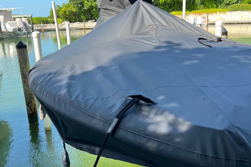 Island Time Yacht Photos Pics Covered 2020 Barker Boatworks 26 Open at dock, surrounded by calm water and greenery.