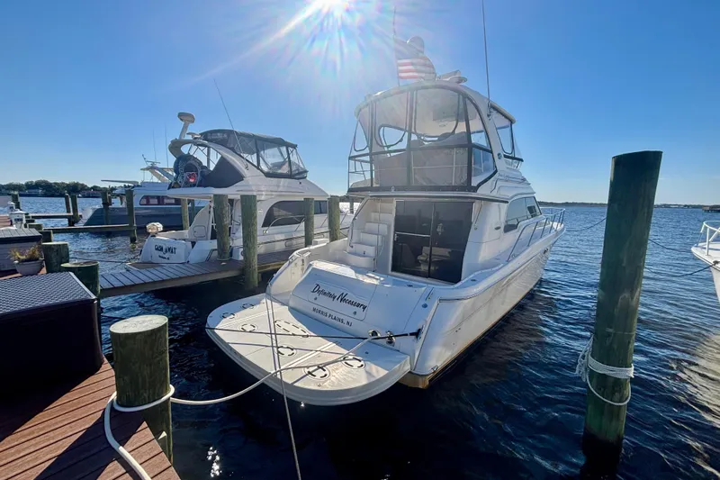  Yacht Photos Pics 2003 Sea Ray 480 Sedan Bridge yacht docked under sunny skies.