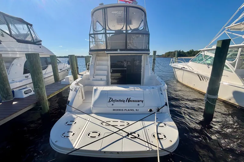  Yacht Photos Pics 2003 Sea Ray 480 Sedan Bridge yacht docked at marina, rear view.