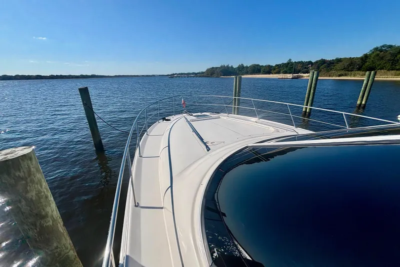  Yacht Photos Pics 2003 Sea Ray 480 Sedan Bridge yacht docked on a sunny day, scenic water view.