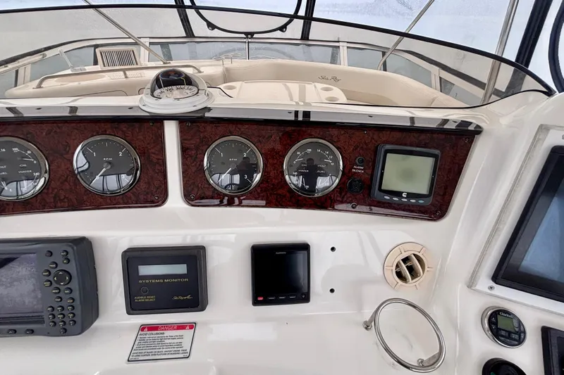  Yacht Photos Pics 2003 Sea Ray 480 Sedan Bridge dashboard with gauges and navigation equipment.