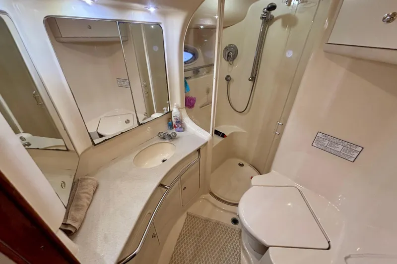  Yacht Photos Pics Luxurious bathroom in 2003 Sea Ray 480 Sedan Bridge yacht, featuring modern amenities and elegant design.