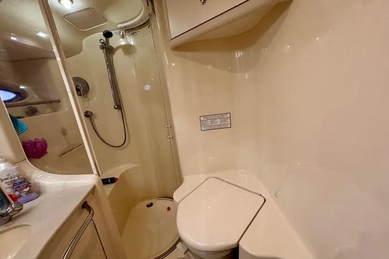  Yacht Photos Pics Bathroom interior of 2003 Sea Ray 480 Sedan Bridge yacht, featuring shower and toilet.