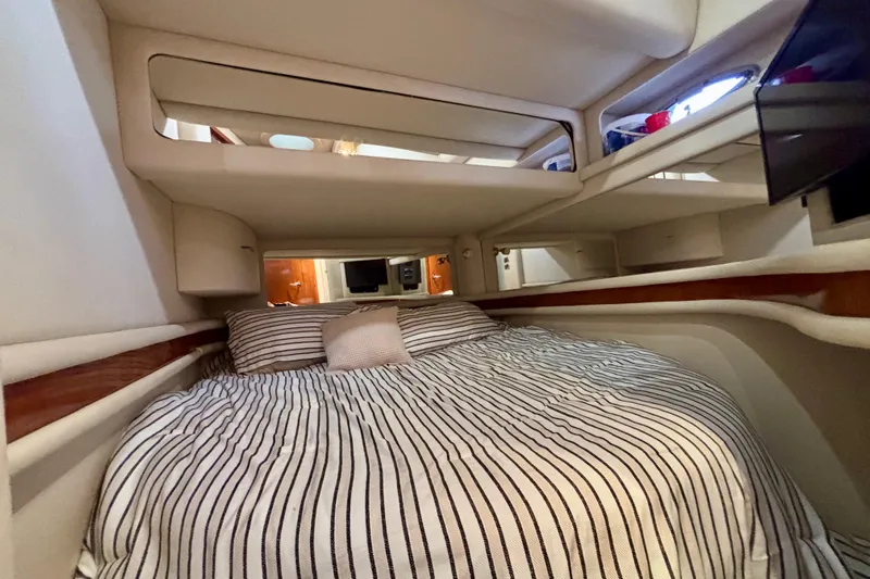  Yacht Photos Pics 2003 Sea Ray 480 Sedan Bridge cabin interior with striped bedding and modern design.