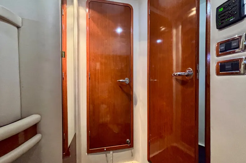  Yacht Photos Pics Interior view of 2003 Sea Ray 480 Sedan Bridge with wooden doors and control panel.