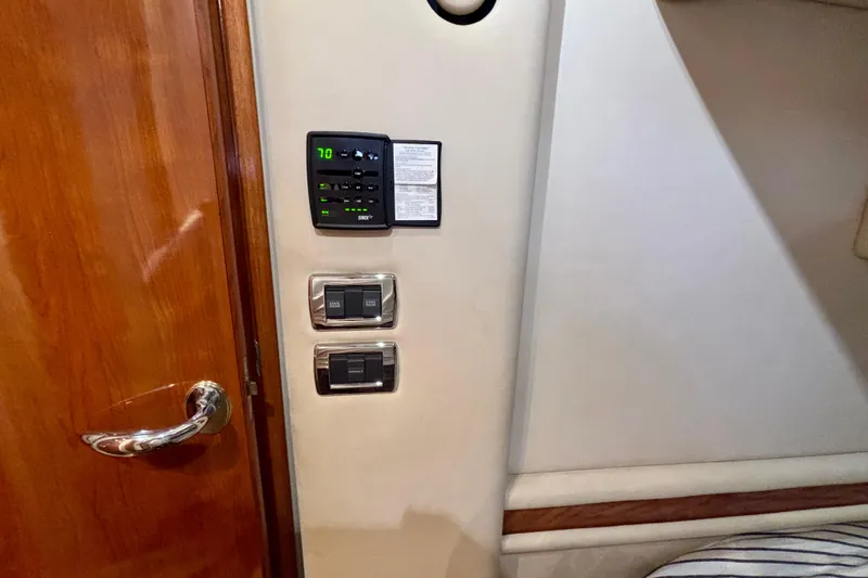  Yacht Photos Pics Interior of 2003 Sea Ray 480 Sedan Bridge with control panel and wooden door.