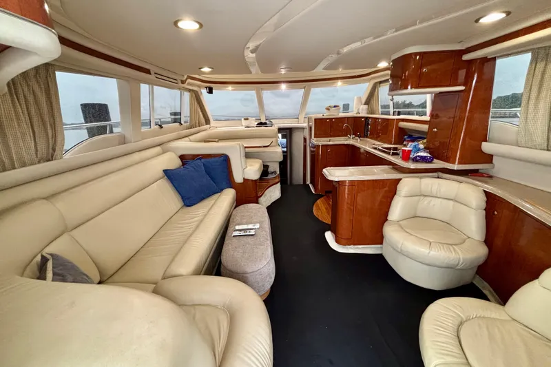  Yacht Photos Pics Luxurious interior of a 2003 Sea Ray 480 Sedan Bridge yacht with leather seating and wood finishes.