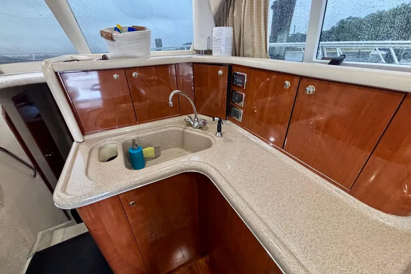  Yacht Photos Pics 2003 Sea Ray 480 Sedan Bridge yacht kitchen with wood cabinets and countertop sink.