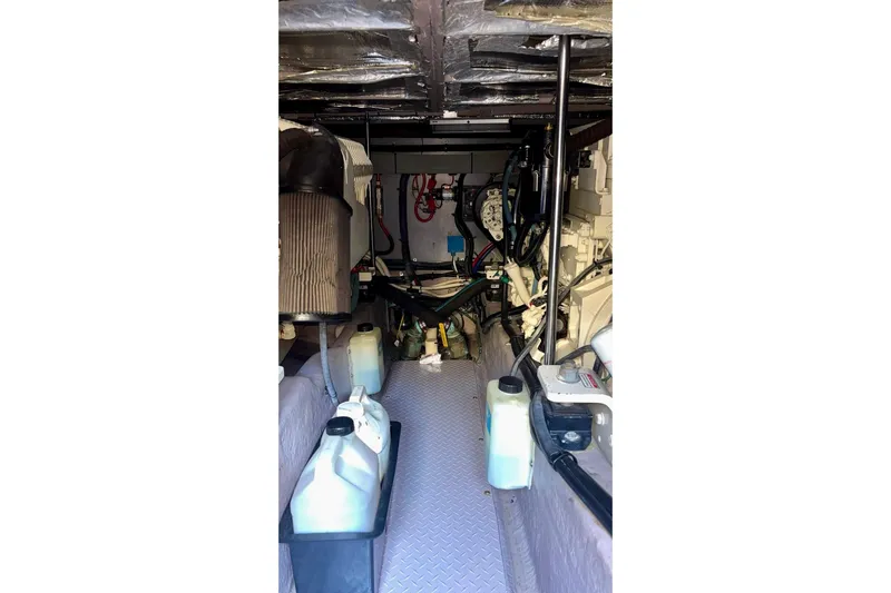  Yacht Photos Pics Engine room of 2003 Sea Ray 480 Sedan Bridge with mechanical components and containers.