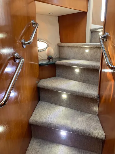 Ocean Life Yacht Photos Pics Staircase inside 2000 Carver 530 Voyager Pilothouse with carpet and wooden handrails.