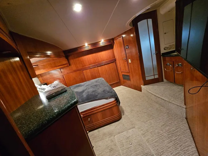 Ocean Life Yacht Photos Pics Luxurious interior of 2000 Carver 530 Voyager Pilothouse with wood paneling and cozy bed.