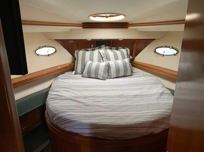 Ocean Life Yacht Photos Pics Luxurious bedroom in 2000 Carver 530 Voyager Pilothouse yacht with striped bedding.