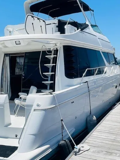 Ocean Life Yacht Photos Pics 2000 Carver 530 Voyager Pilothouse yacht docked at marina, side view.