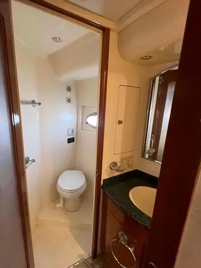 Ocean Life Yacht Photos Pics Bathroom interior of 2000 Carver 530 Voyager Pilothouse yacht, featuring toilet and sink.