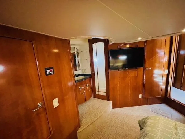 Ocean Life Yacht Photos Pics Luxurious interior of 2000 Carver 530 Voyager Pilothouse with wood paneling and modern amenities.