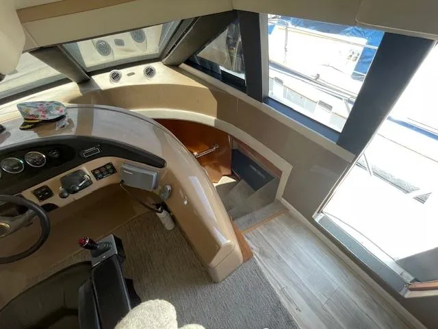 Ocean Life Yacht Photos Pics Interior view of 2000 Carver 530 Voyager Pilothouse helm with controls and seating.