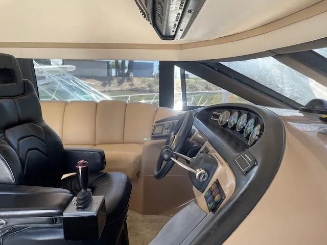 Ocean Life Yacht Photos Pics Pilothouse interior of 2000 Carver 530 Voyager, featuring leather seating and control panel.