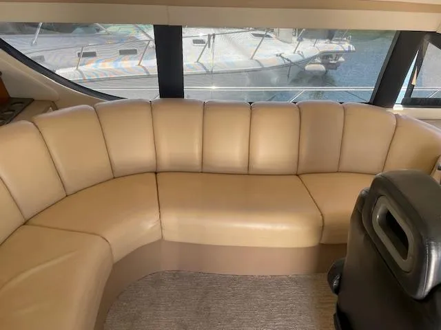 Ocean Life Yacht Photos Pics Interior of 2000 Carver 530 Voyager Pilothouse with beige leather seating and large windows.