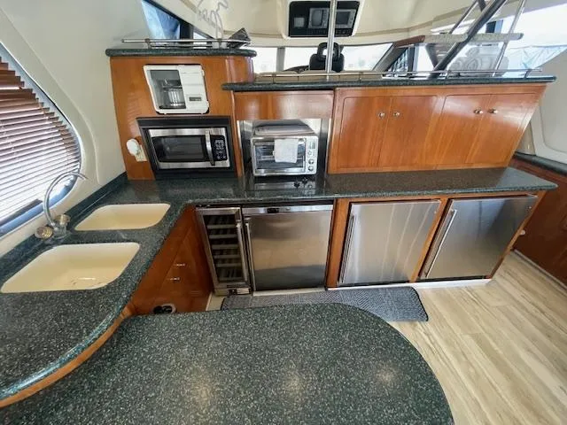 Ocean Life Yacht Photos Pics Luxurious kitchen in 2000 Carver 530 Voyager Pilothouse with modern appliances and sleek countertops.