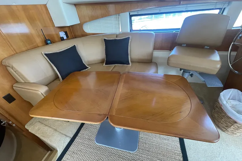  Yacht Photos Pics 2002 Carver 346 Aft Cabin interior with beige seating and wooden table.