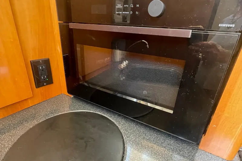  Yacht Photos Pics Microwave in 2002 Carver 346 Aft Cabin kitchen with wooden cabinetry.